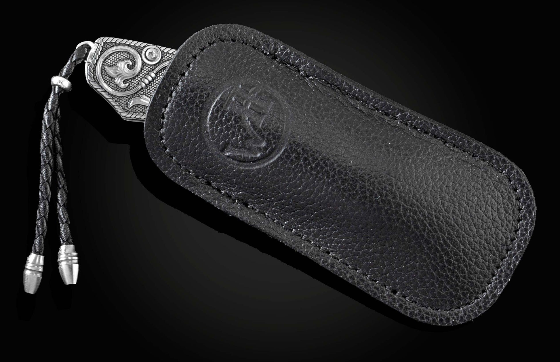 Handcrafted pocket knife from William Henry features hand and laser engraved handles set with sapphire gemstones and a blade of hand-forged Damascus steel.