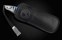 Handcrafted pocket knife from William Henry features a hand-carved sterling silver depicting a dragons head and tail
