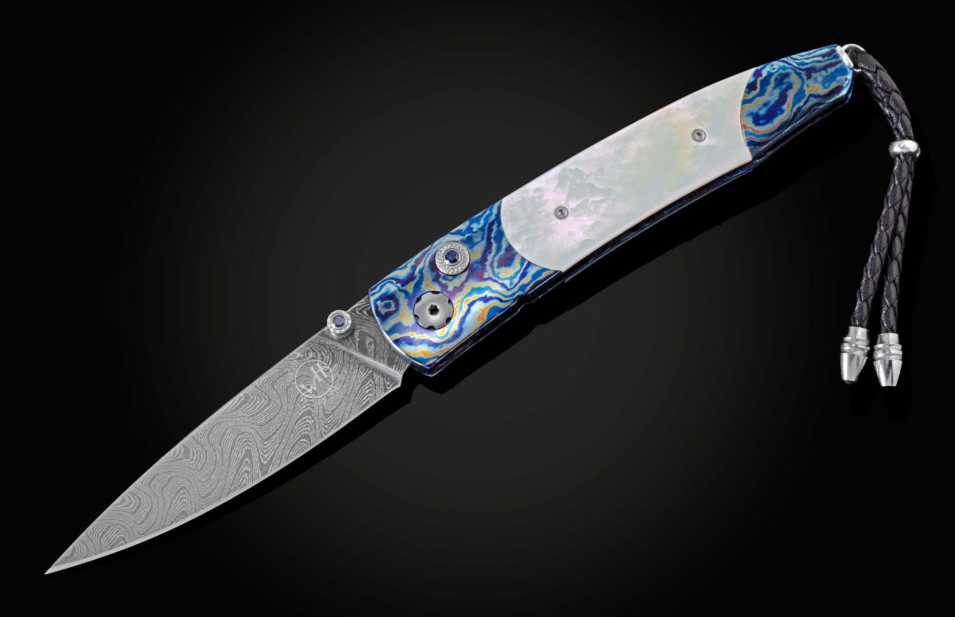 Pocket knife from William Henry featuring a hand forged Damascus steel blade and a frame of hand-forged Ukrainian 'Moku-ti' Damascus