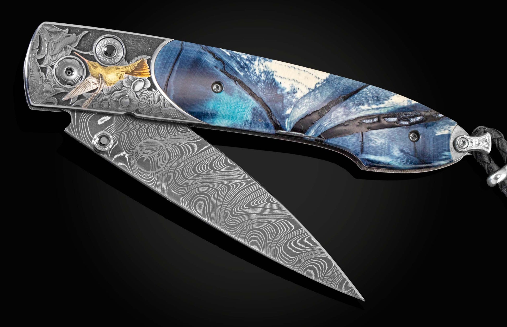 Handcrafted William Henry knife with hand-engraved frame featuring hummingbirds in 24K & 18K green gold, silver, and copper by Thierry Duguet, inlaid with fossil woolly mammoth tusk, spinel gemstones and a hand-forged damascus steel blade by Chad Nichols