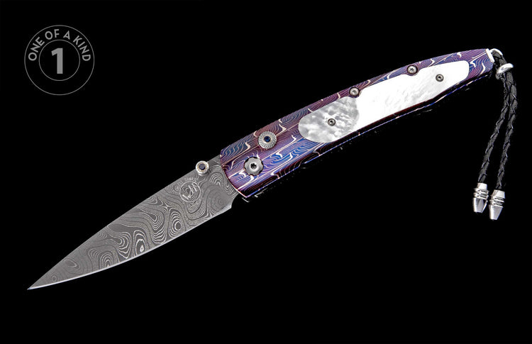 Custom folding knife with a swirling Damascus steel blade, vibrant purple and blue handle with mother-of-pearl inlay, and black leather lanyard.