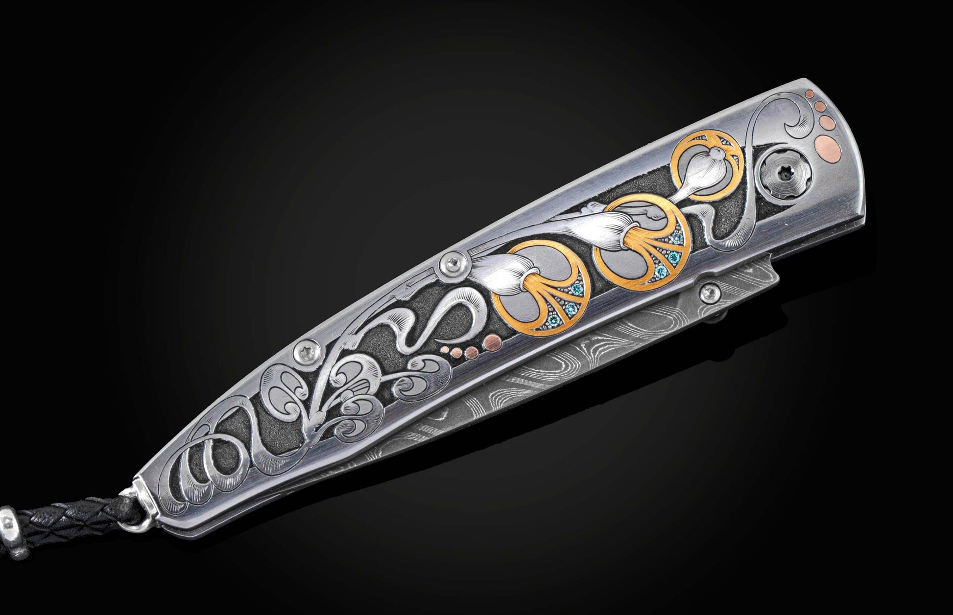  24K gold and blue diamonds depicting an abstract floral design. The knife is displayed partially open on a black backgroun