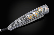  24K gold and blue diamonds depicting an abstract floral design. The knife is displayed partially open on a black backgroun