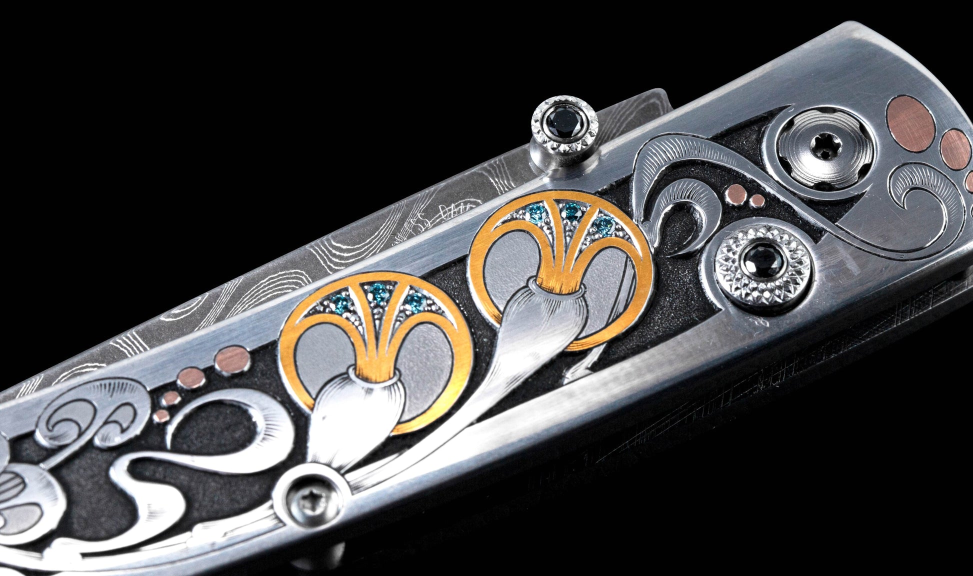Hand forged Damascus steel blade pocket knife from William Henry features a beautiful hand-engraved frame with inlaid 14K rose gold
