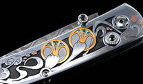 Hand forged Damascus steel blade pocket knife from William Henry features a beautiful hand-engraved frame with inlaid 14K rose gold