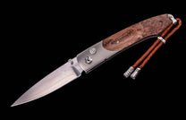 Silver blade knife with dark brown burled wood and brushed silver handle, featuring a brown braided leather lanyard.