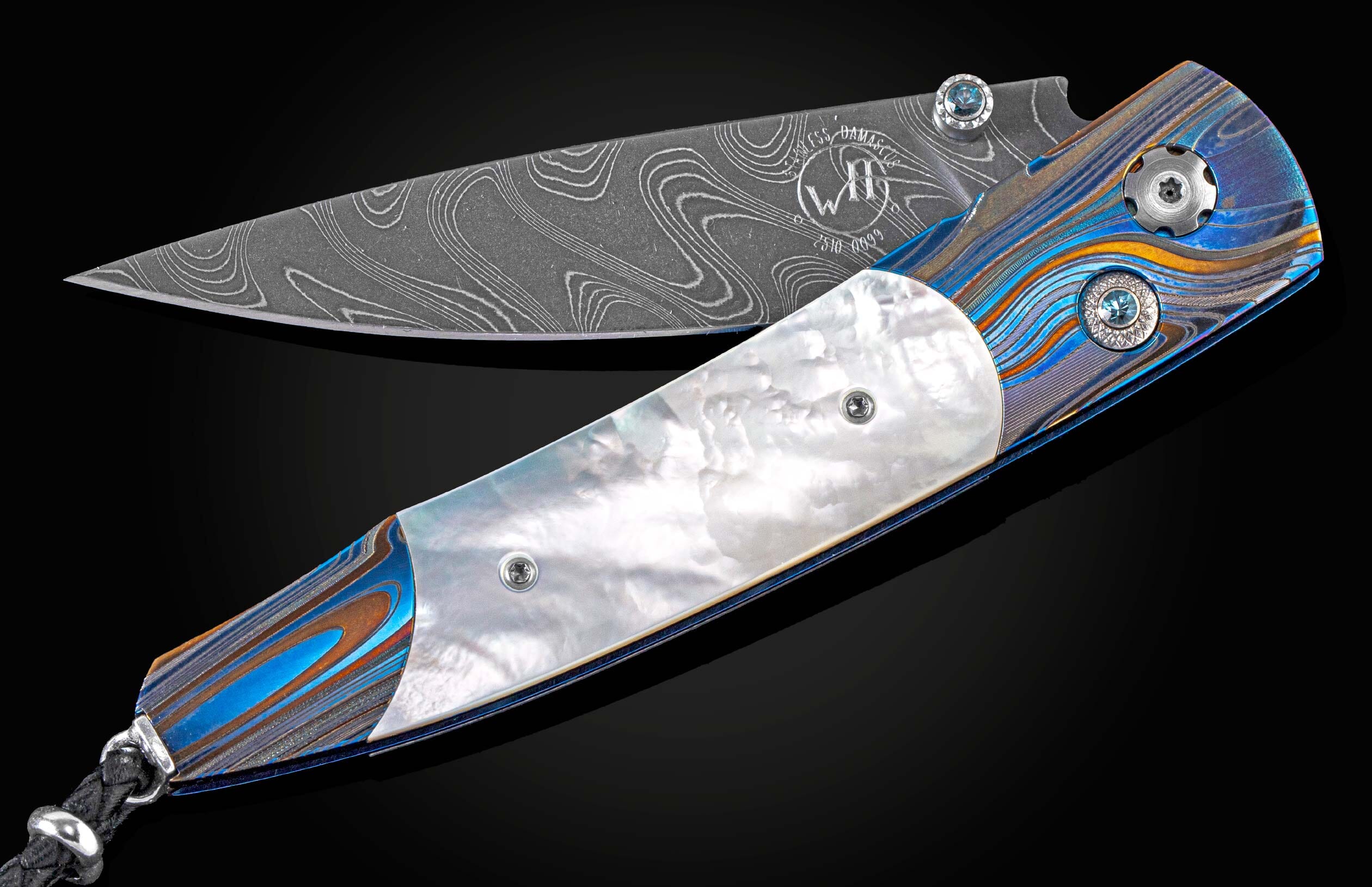 Exclusive edition knife from William Henry with a 'Laser Blue' finished frame in aerospace grade titanium, mother of pearl scales, London Blue topaz and a hand-forged damascus steel blade by Chad Nichols