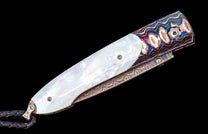 Folding knife with iridescent mother-of-pearl handle, wavy colorful patterned metal, and braided leather lanyard.