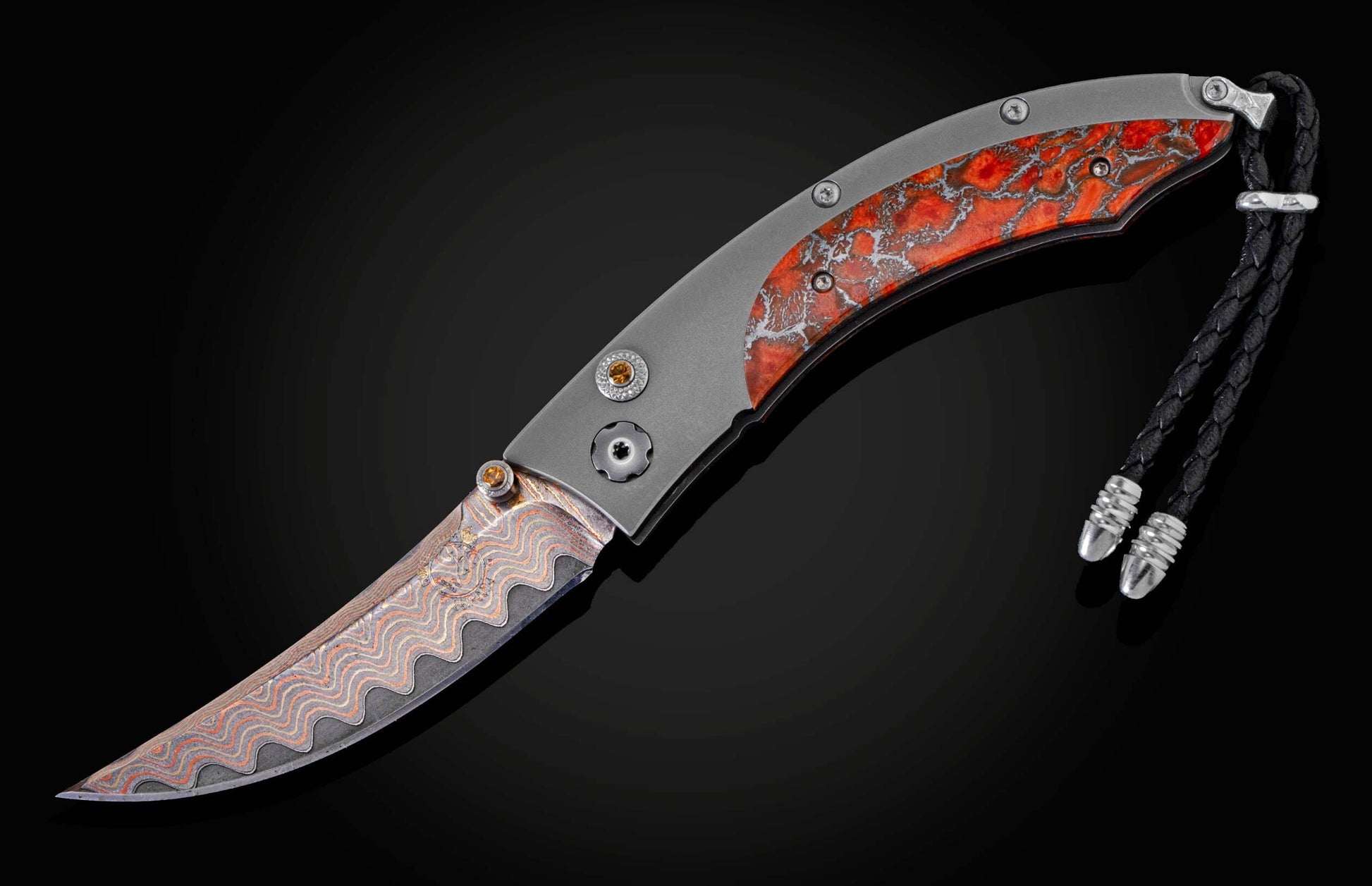 Handcrafted pocket knife from William Henry features a titanium frame inlaid with orange and red zinc matrix Apple Coral. The button lock and the thumb stud have been set with citrine gemstones and the hand forged Damascus steel blade has a copper wave pa