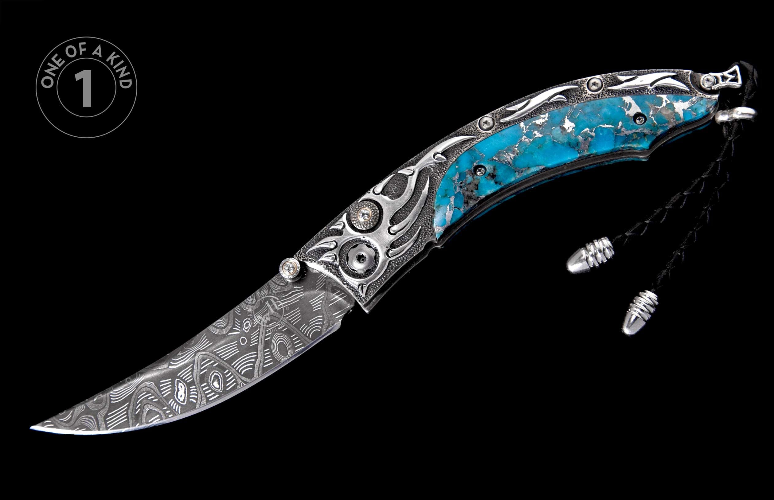 Folding knife with patterned Damascus blade, ornate silver handle with blue turquoise inlay, small clear stones, and a black leather lanyard.