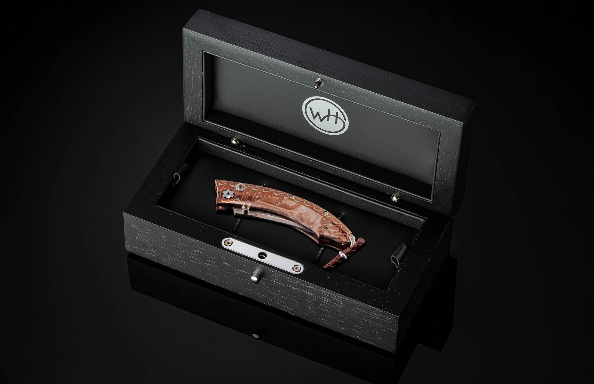  inlaid with maple burl wood. The blade is 'Copper Wave' Damascus steel with a VG5 core. The button lock and the thumb stud are set with citrine gems