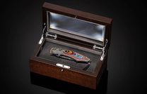 and 24K gold inlaid with Corvette Fordite and set with black diamonds. The blade is hand-forged damascus.