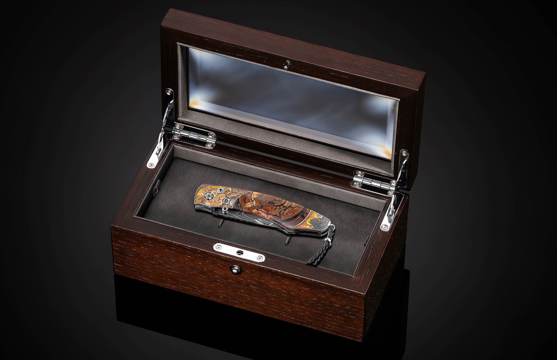 Handcrafted William Henry knife with hand-engraved frame depicting lions in 24K gold