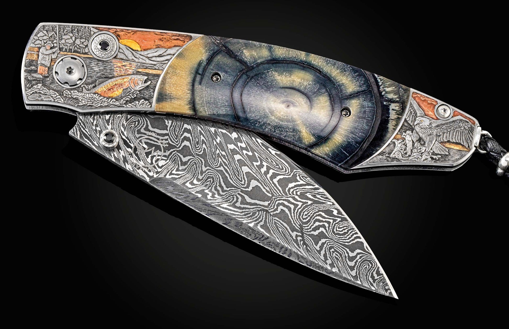 Handcrafted William Henry knife features 24K yellow gold, copper, brass, and silver inlays by Narimantis Palsis depicting Alaskan wildlife, inlaid with fossil Woolly Mammoth tusk, spinel gemstone, and a hand-forged Damascus steel blade by Zoe Crist