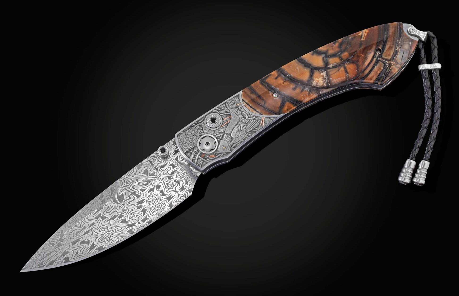 Candcrafted pocket knife from William Henry featuring hand-engraved grouse and quail with copper and 24K gold inlaid with fossil Woolly Mammoth tusk and set with spinel gem stones.. The blade is hand-forged damascus steel.