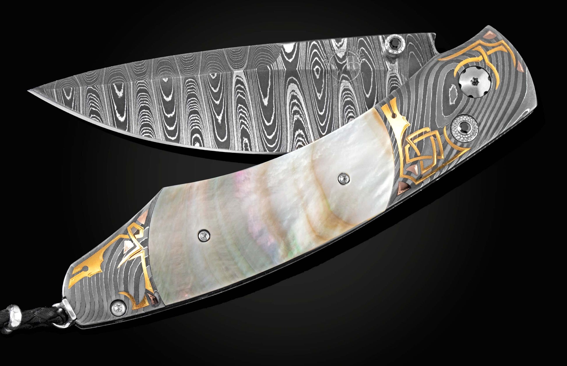 Handcrafted knife from William Henry features Hand-forged Damascus steel bolsters with gold inlays. The scales are black lip pearl, and the blade is crafted from Damascus steel, hand-forged with Gibeon Meteorite and set with spinel gemstones.