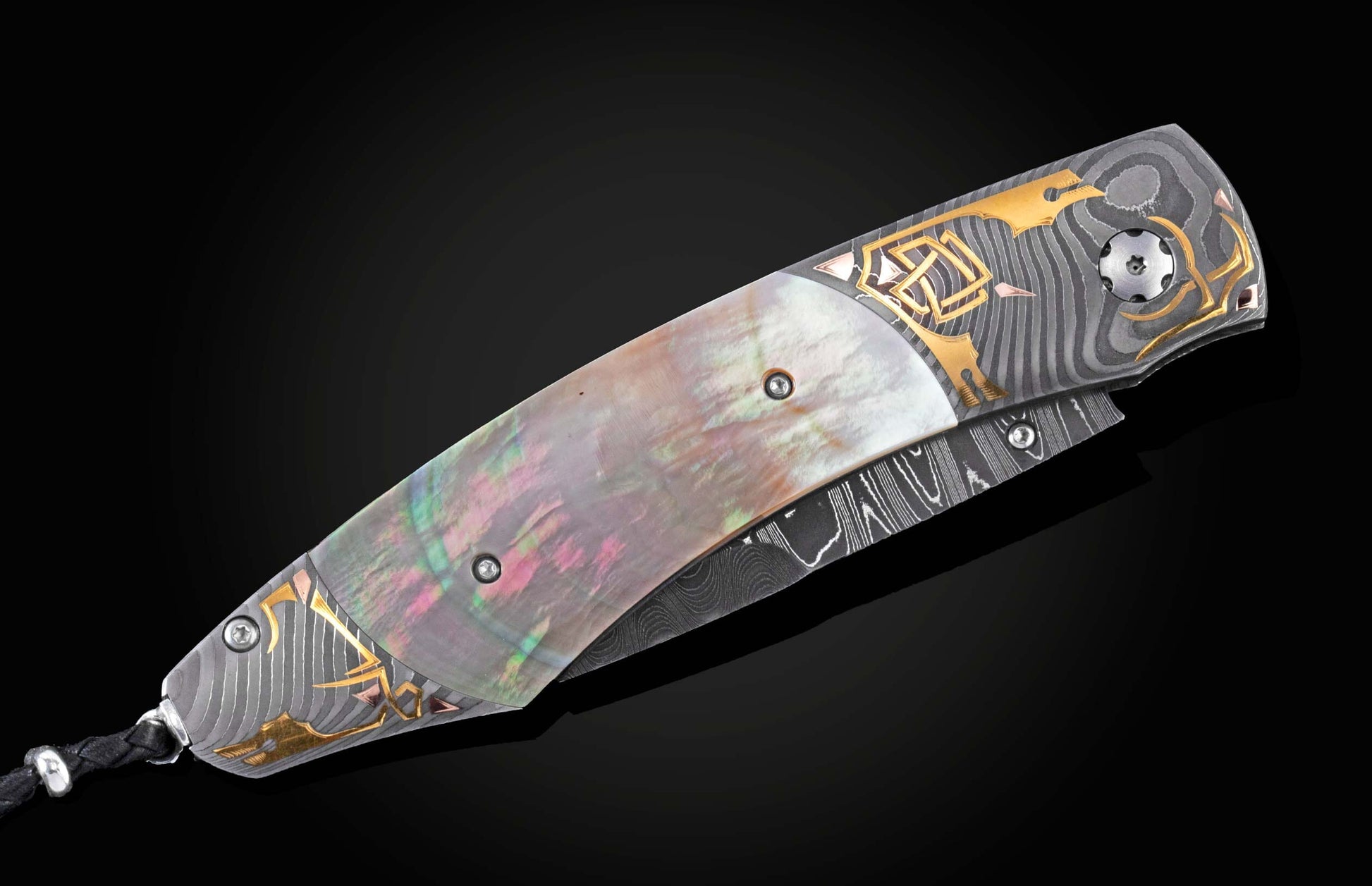 Handcrafted knife from William Henry features Hand-forged Damascus steel bolsters with gold inlays. The scales are black lip pearl