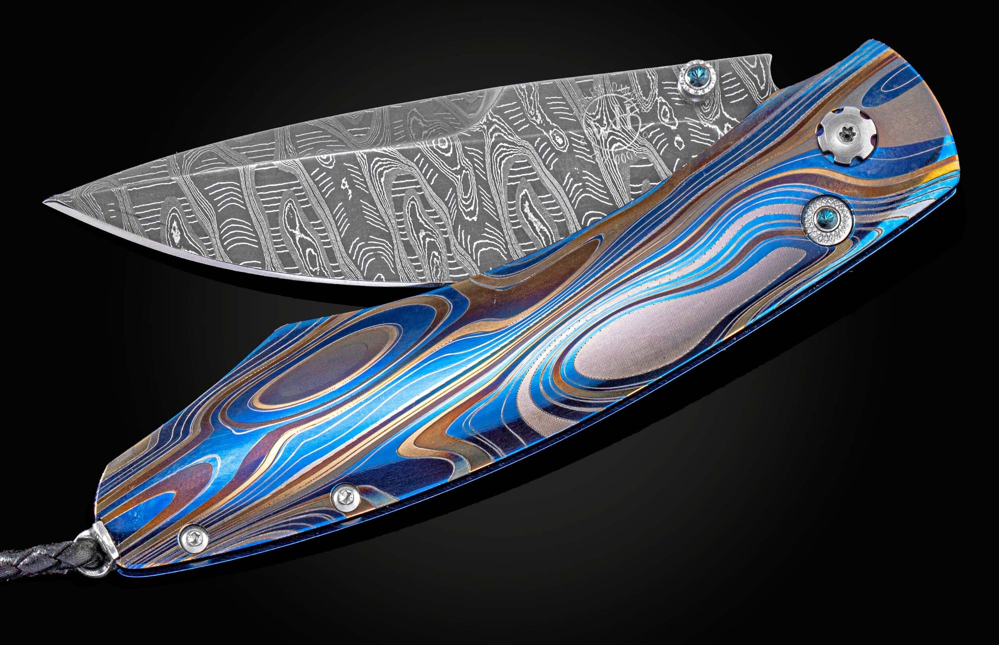 Custom knife from William Henry features a color laser-engraved titanium frame, London Blue topaz gemstones, and a hand-forged damascus steel blade by Mike Norris