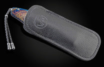 Handcrafted William Henry pocket knife features hand-forged and anodized blue damascus frame by Chad Nichols