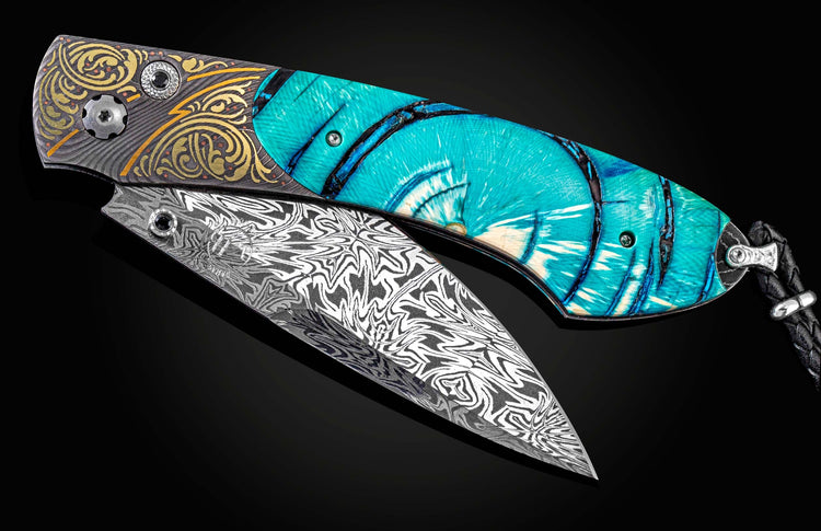 Handcrafted knife from William Henry featuring a hand-forged damascus frame by Chad Nichols with copper & gold inlays by Tyler Prince, fossil Woolly Mammoth tusk, spinel gemstones and a hand-forged damascus steel blade by Luke Mattern