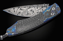 Custom William Henry knife with Moku-Ti frame, carbon fiber scales, and damascus blade