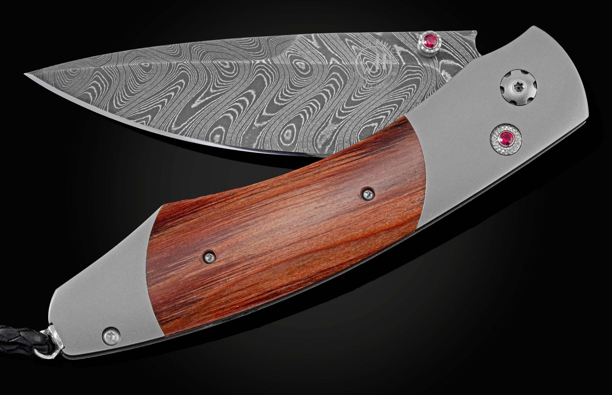 The ‘Buckeye’ pocket knife from William Henry features a titanium frame, inlaid with reclaimed wood from the seats of Ohio Stadium. The blade is hand-forged Damascus steel and the button lock and the thumb stud are set with rubies. The knife is shown part