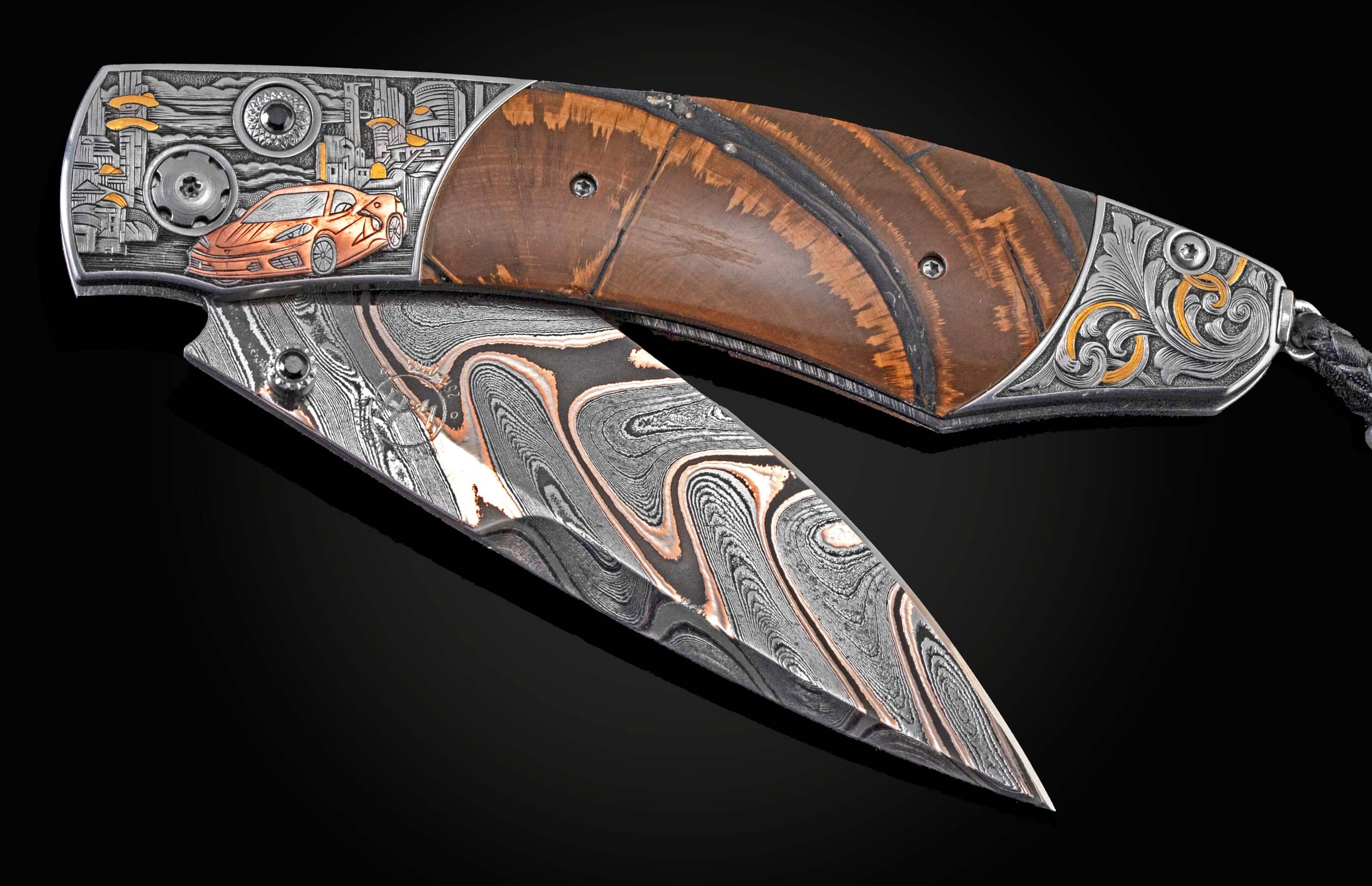 Handcrafted William Henry knife with hand-engraved bolster in copper and 24K gold inlays by David He showing a Corvette and cityscape, inlaid with fossil Woolly Mammoth tusk, spinel gem stones, and a hand forged bronze damascus steel blade by Baker Forge