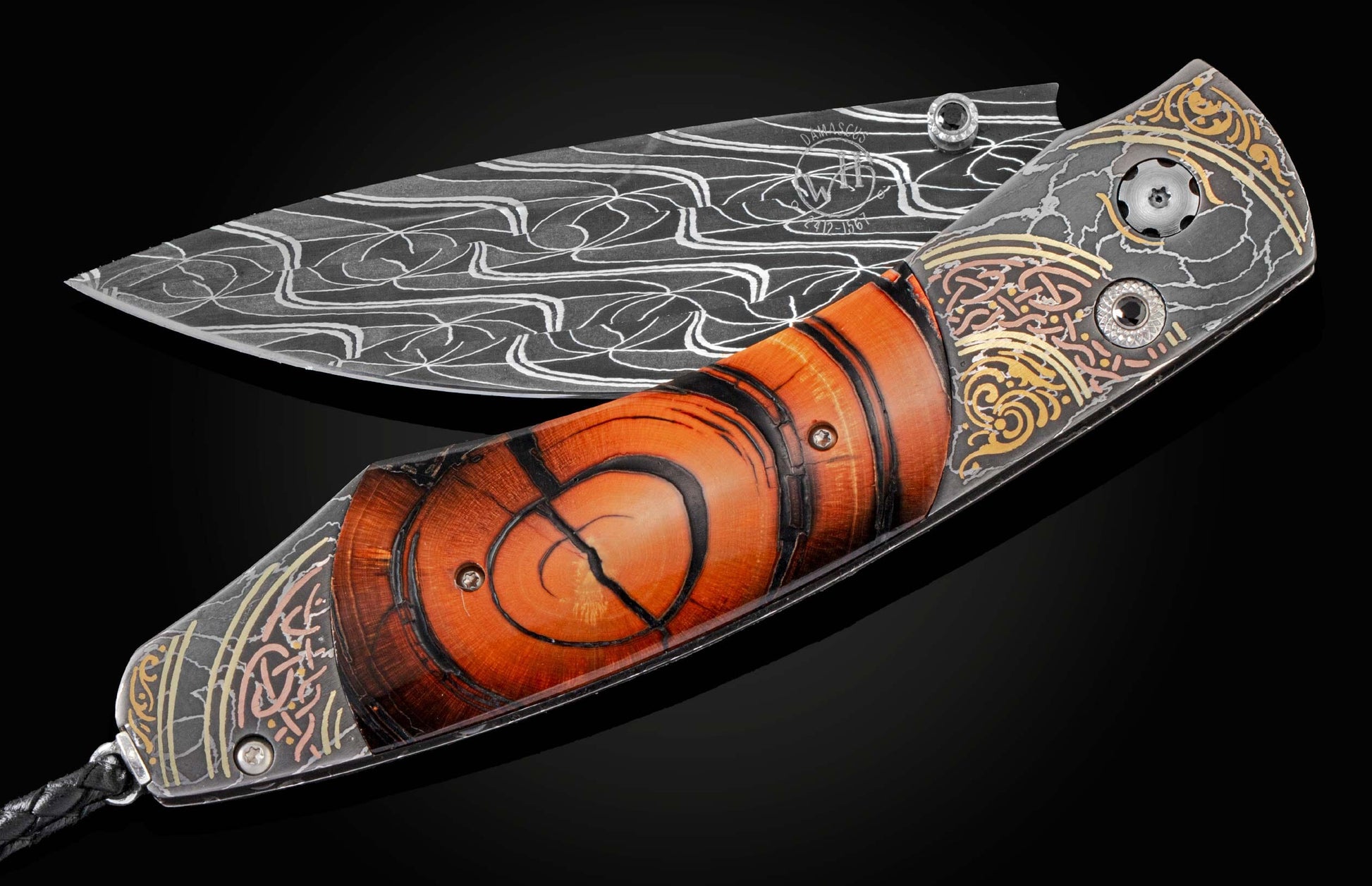 Handcrafted pocket knife from William Henry features hand-forged damascus, hand-engraved with copper, 24k and 22k yellow gold, and 18k green gold inlays with spinel gemstones, inlaid with fossil Woolly Mammoth tusk. The blade is hand-forged damascus steel