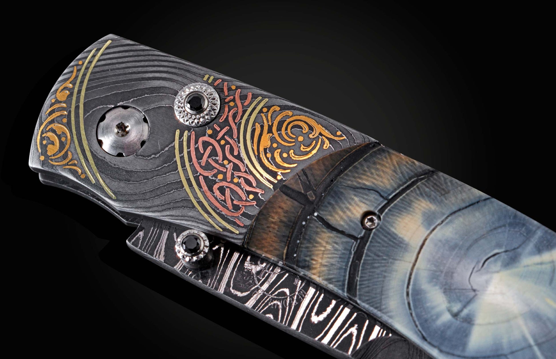 Handcrafted pocket knife from William Henry features a hand-forged damascus steel frame with 24K and 22K yellow gold