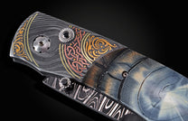 Handcrafted pocket knife from William Henry features a hand-forged damascus steel frame with 24K and 22K yellow gold