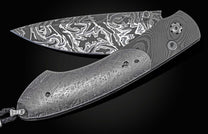 Handcrafted pocket knife from William Henry with a frame of hand-forged 'Twist' Damascus by Chad Nichols, inlaid with Gibeon meteorite scales, a hand forged Damascus steel blade by Luke Mattern, and set with black diamonds.