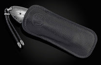 Handcrafted pocket knife from William Henry with a frame of hand-forged 'Twist' Damascus by Chad Nichols
