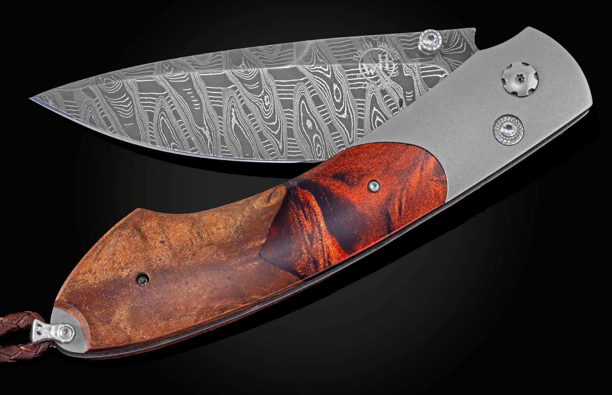 Handcrafted William Henry knife featuring a titanium frame, inlaid with natural wood and colored resin, white topaz gemstones and a hand-forged damascus steel blade by Mike Norris