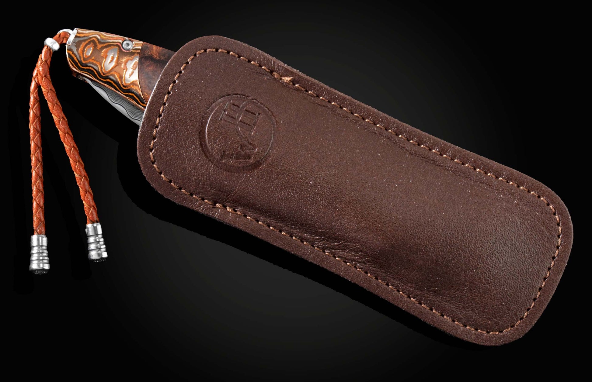 Handcrafted pocket knife from William Henry features a beautiful frame in heat-colored 'Wave Mokume'