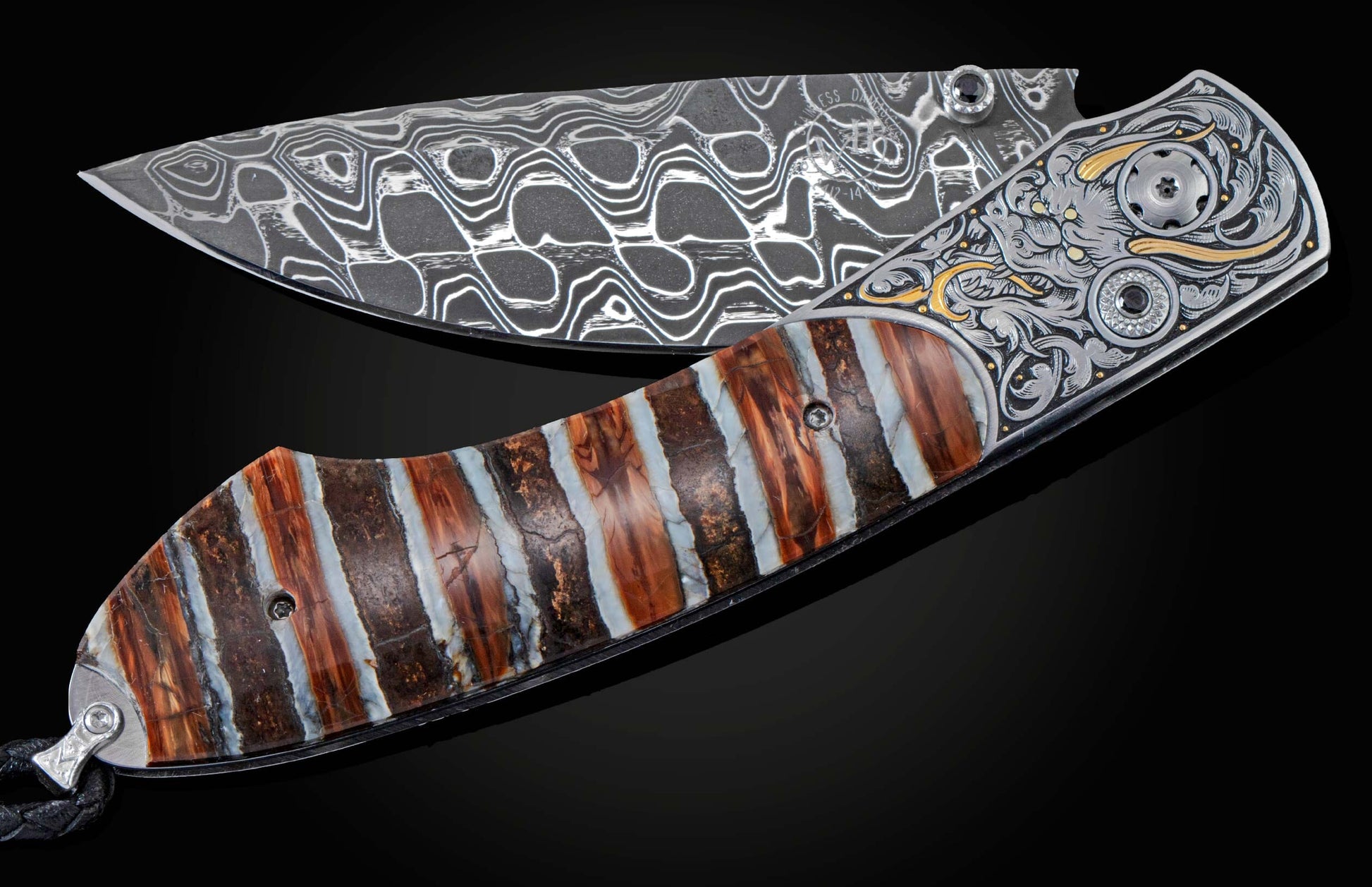 Folding knife with a patterned Damascus blade, engraved bolster with gold and black gemstones, and a striped brown and white handle.