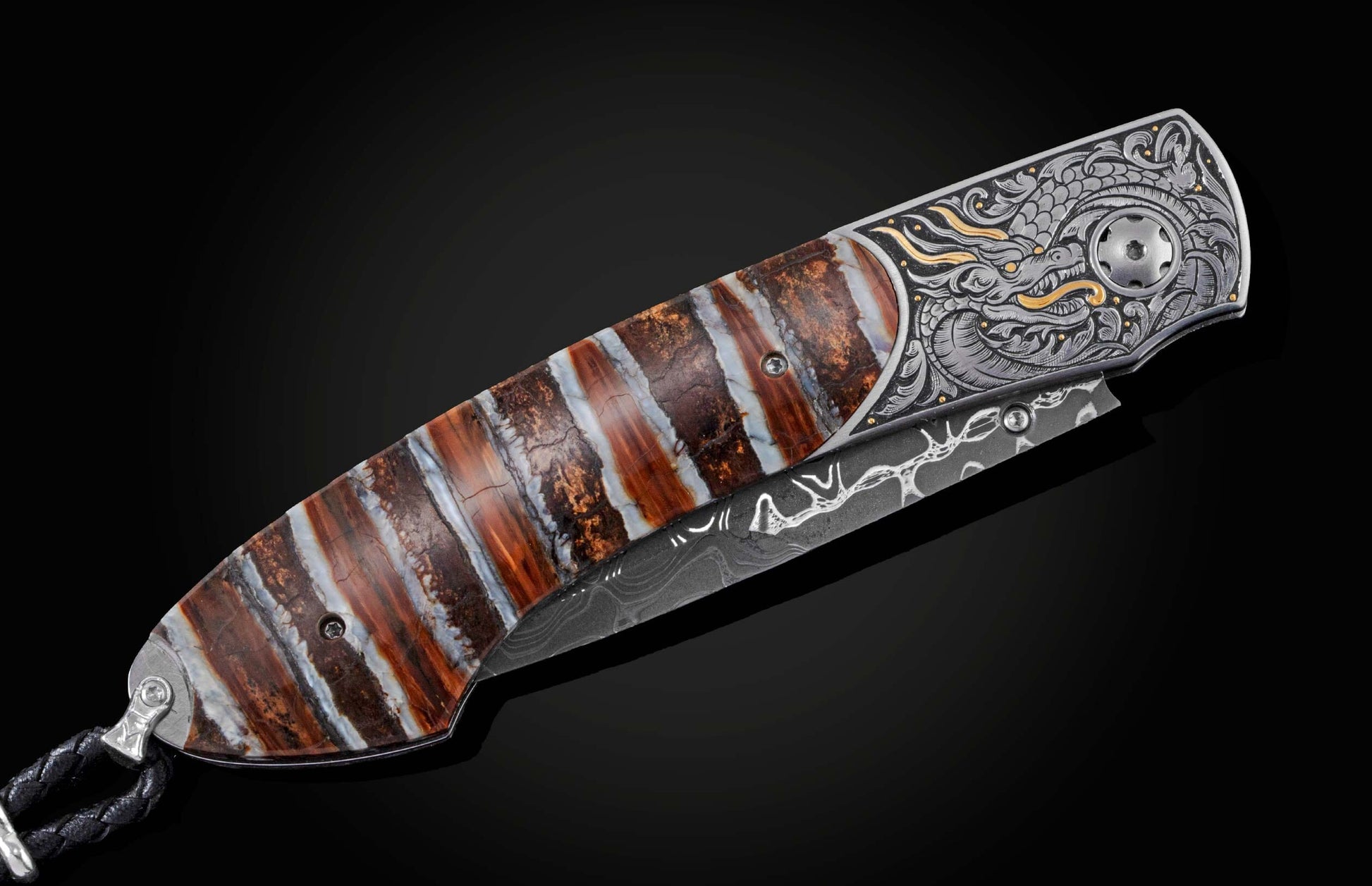Custom folding knife featuring a striped fossilized wood handle, intricately engraved silver bolster with a gold dragon design, and Damascus steel blade.