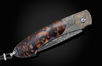  and copper inlays with spinel gemstones. The scales are made from ring-cut fossil Woolly Mammoth tusk. The blade is hand-