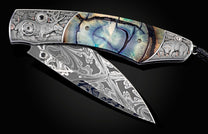 Custom William Henry knife with hand-engraved scenes of elk with copper and 24K gold inlays by Howard Thomas, fossil Woolly Mammoth tusk, spinel gem stones, and a hand-forged damascus steel blade by Luke Mattern
