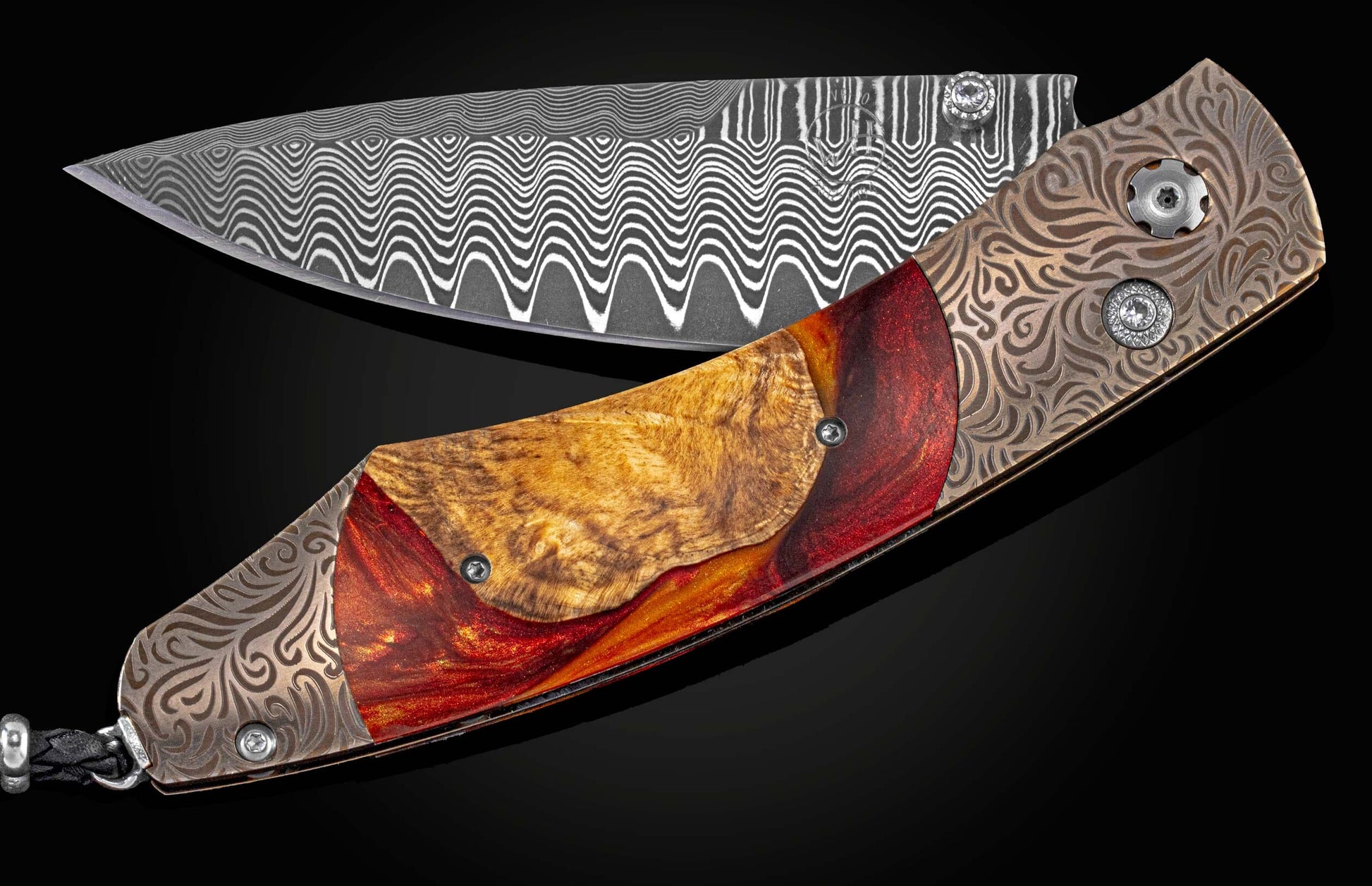 Handcrafted William Henry knife with a brown/gold laser-engraved anodized titanium frame, wood and resin hybrid inlay, white topaz gemstones, and a hand forged damascus steel blade