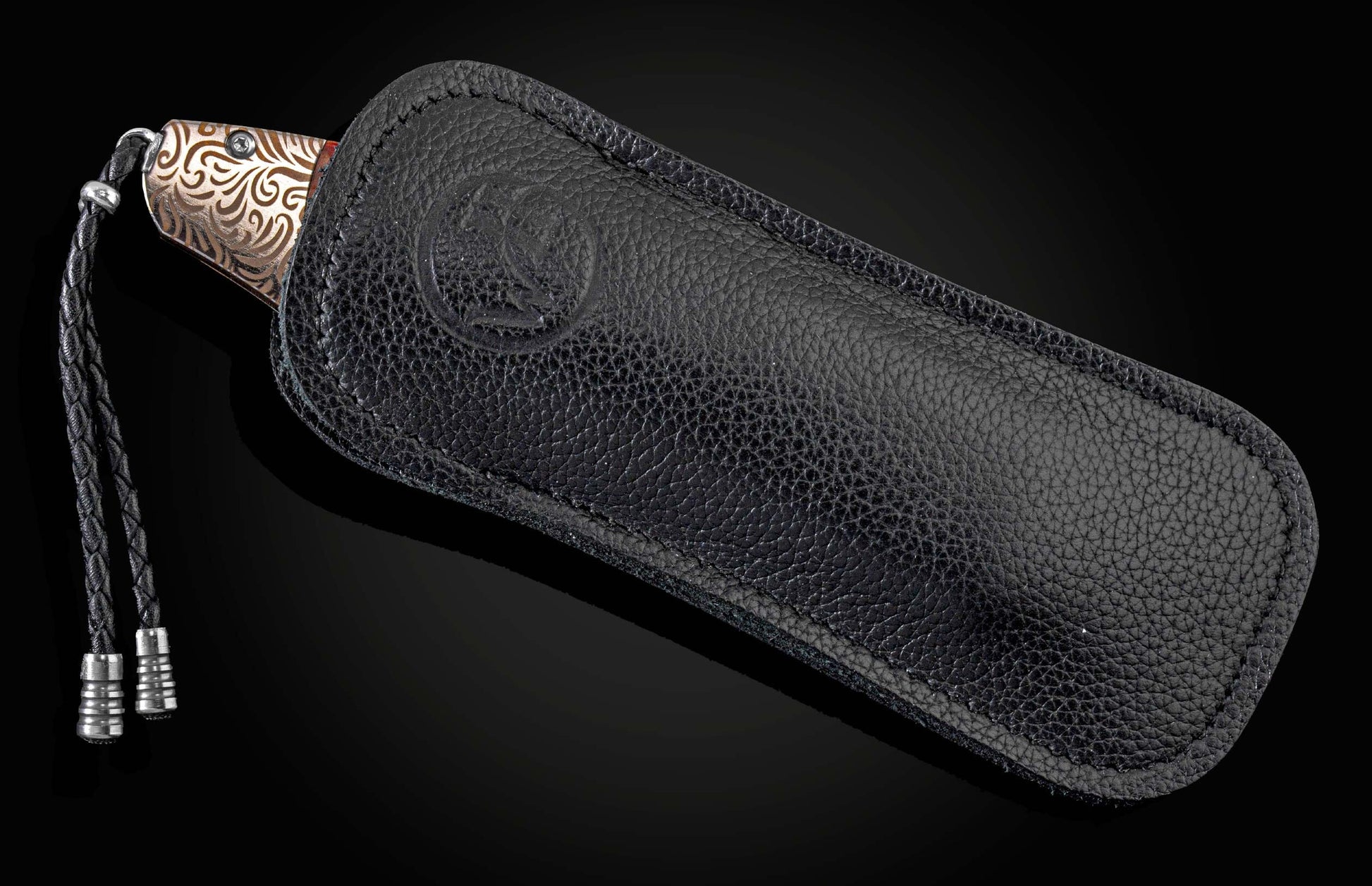 Handcrafted William Henry knife with a brown/gold laser-engraved anodized titanium frame