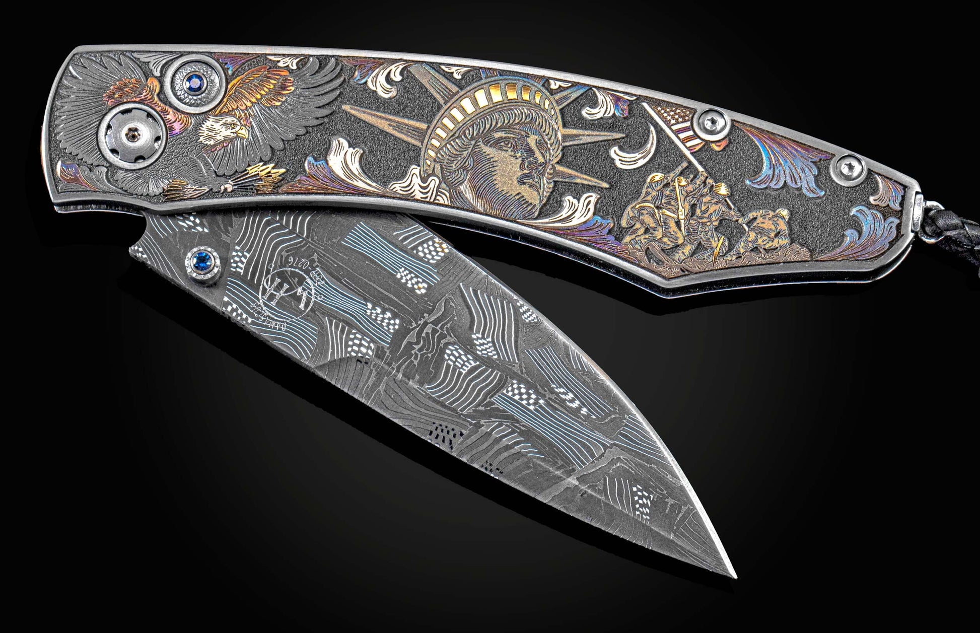 Handcrafted William Henry knife features color laser and hand-engraving work by Bottega Incisioni, blue sapphires, and a hand-forged damascus steel blade by Chad Nichols