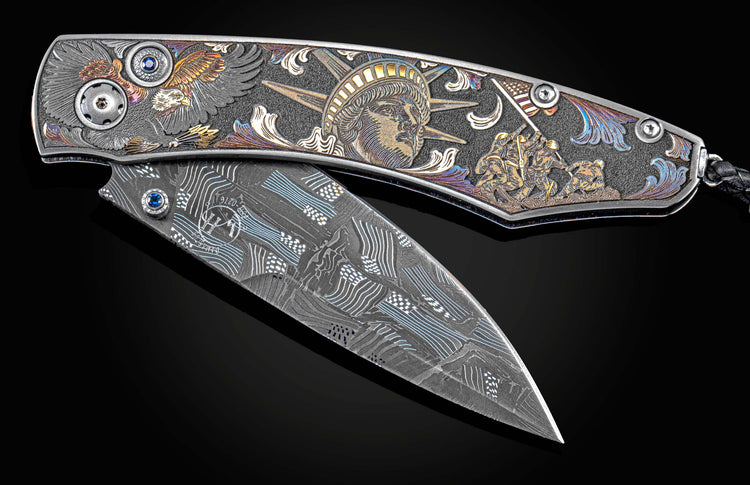 Handcrafted William Henry knife features color laser and hand-engraving work by Bottega Incisioni, blue sapphires, and a hand-forged damascus steel blade by Chad Nichols