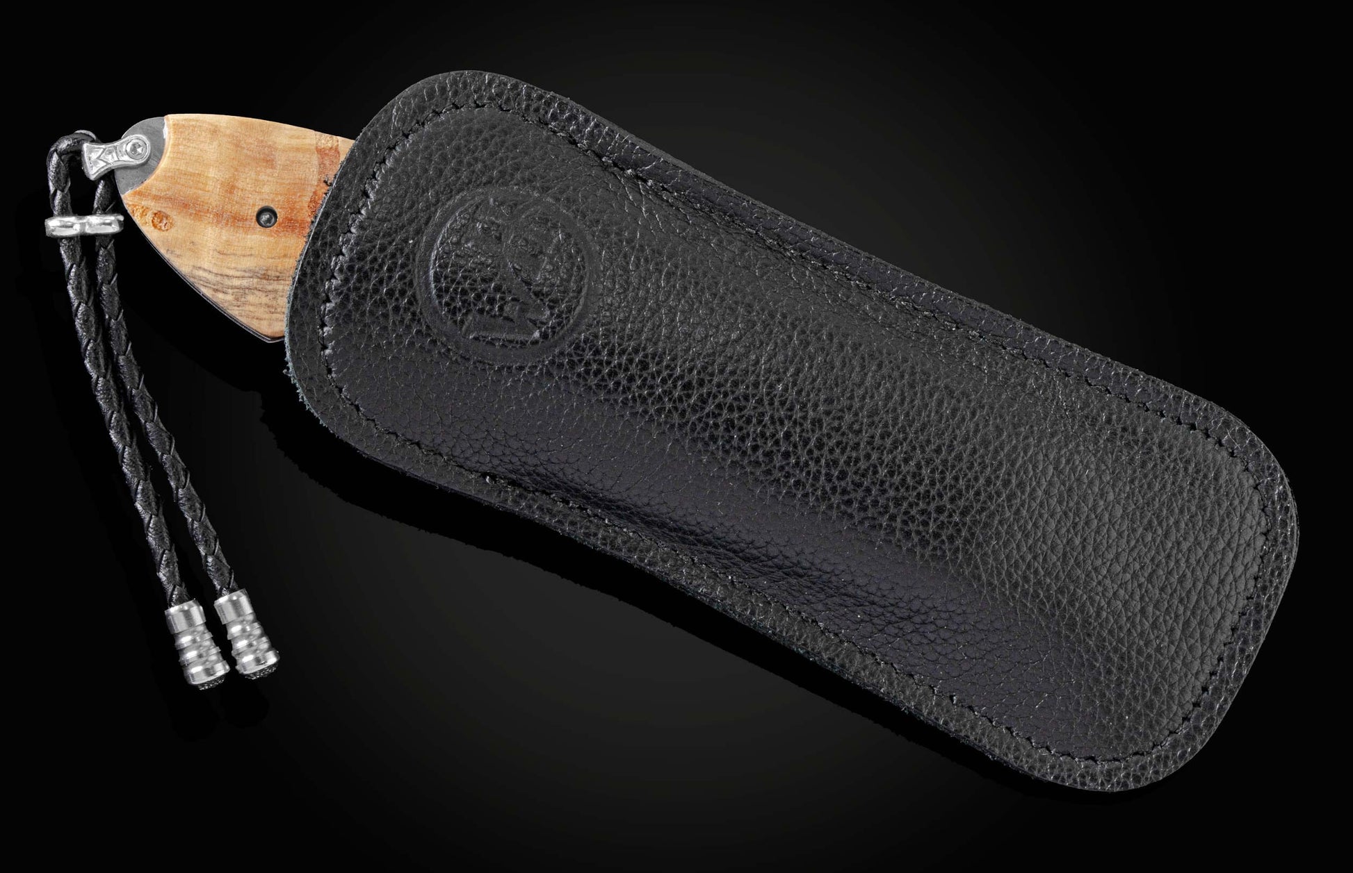 Handcrafted knife from William Henry features hand-engraved depictions of George Washington and the Statue of Liberty inlaid with a wood scale from trees planted by George Washington and set with spinel gemstones.. The blade is hand-forged damascus steel.