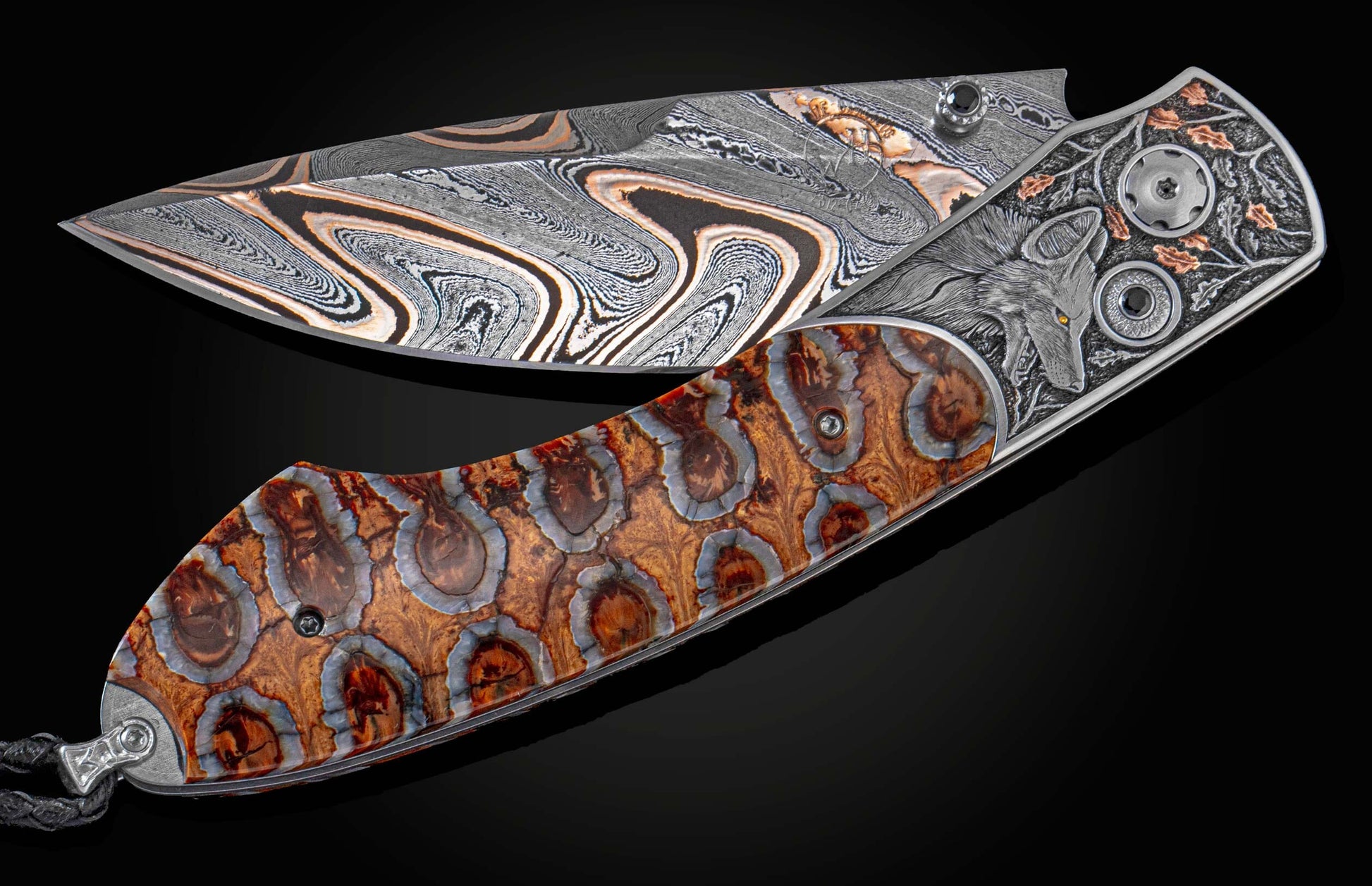 Handcrafted William Henry knife  withhand-engraved bolster with copper and 24K gold inlays by Howard Thomas, fossil Woolly Mammoth tooth, spinel gem stones, and  hand-forged bronze damascus blade by Baker Forge