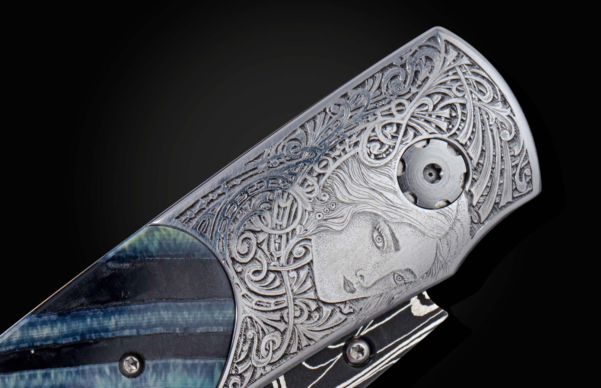  beautifully hand-engraved by Frederique Lepinois depicting a woman's face and intricate scrollwork inlayed with blue 10