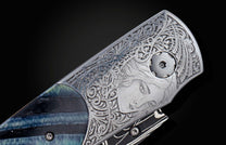  beautifully hand-engraved by Frederique Lepinois depicting a woman's face and intricate scrollwork inlayed with blue 10