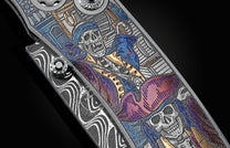 Handcrafted pocket knife from William Henry features beautiful color laser engraving of pirate scenes by Bottega Incisioni in Italy and set with spinel gemstones. The blade is damascus  steel.