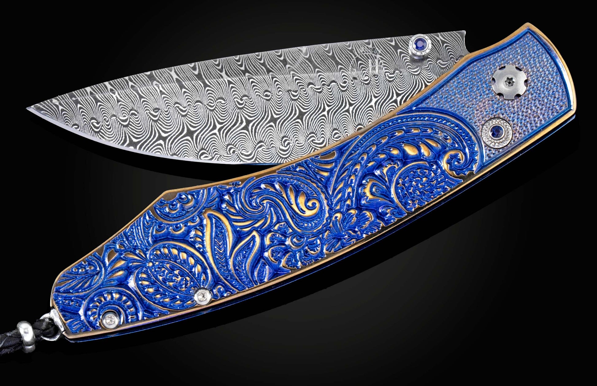Custom William Henry knife featuring blue anodized titanium handle with high detail paisley design, sapphires and a hand-forged damascus steel blade by Maximiliano Pescie.