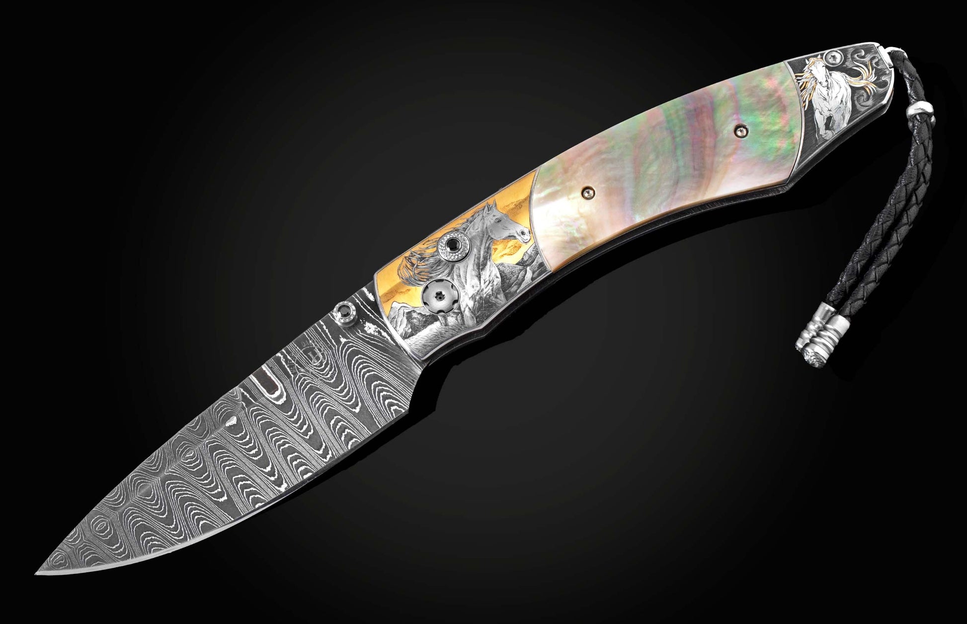 Handcrafted knife from William Henry featuring hand-engraved horses with 24K gold and silver inlays and scales of black lip pearl and stud are set with spinel gemstones. The Damascus steel blade is hand-forged with Gibeon Meteorite.
