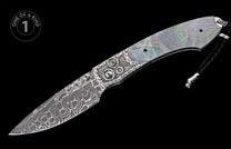 Ornate folding knife with iridescent mother-of-pearl handle, silver gear and chain link details with green gems, wavy Damascus blade, and black lanyard.